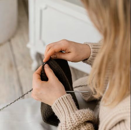 Close up woman knitting with metallic needles 23 2148859241