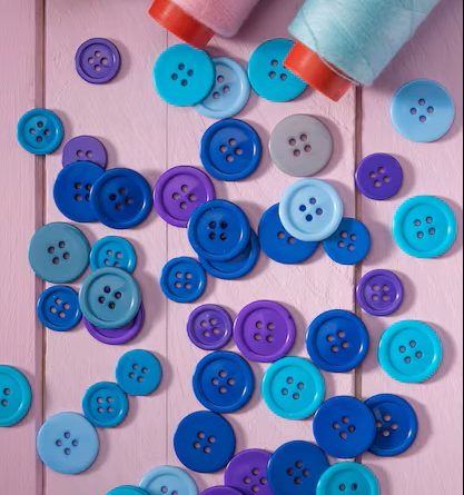 Flat lay blue thread reels with buttons 23 2148527902