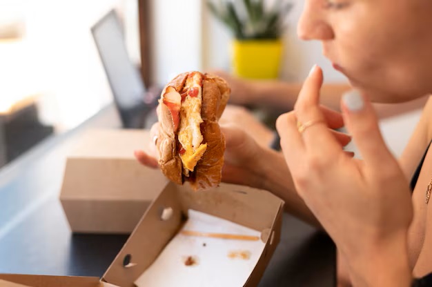 Person enjoying some takeaway burger 23 2149050350