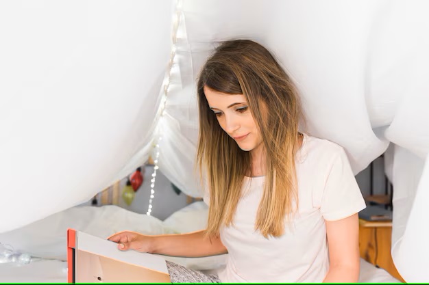 Young woman sitting bed reading book 23 2147890652